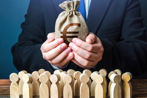 Foto: Mann mit Geldbeutel in den Hände und kleine Holzfiguren stehen davor